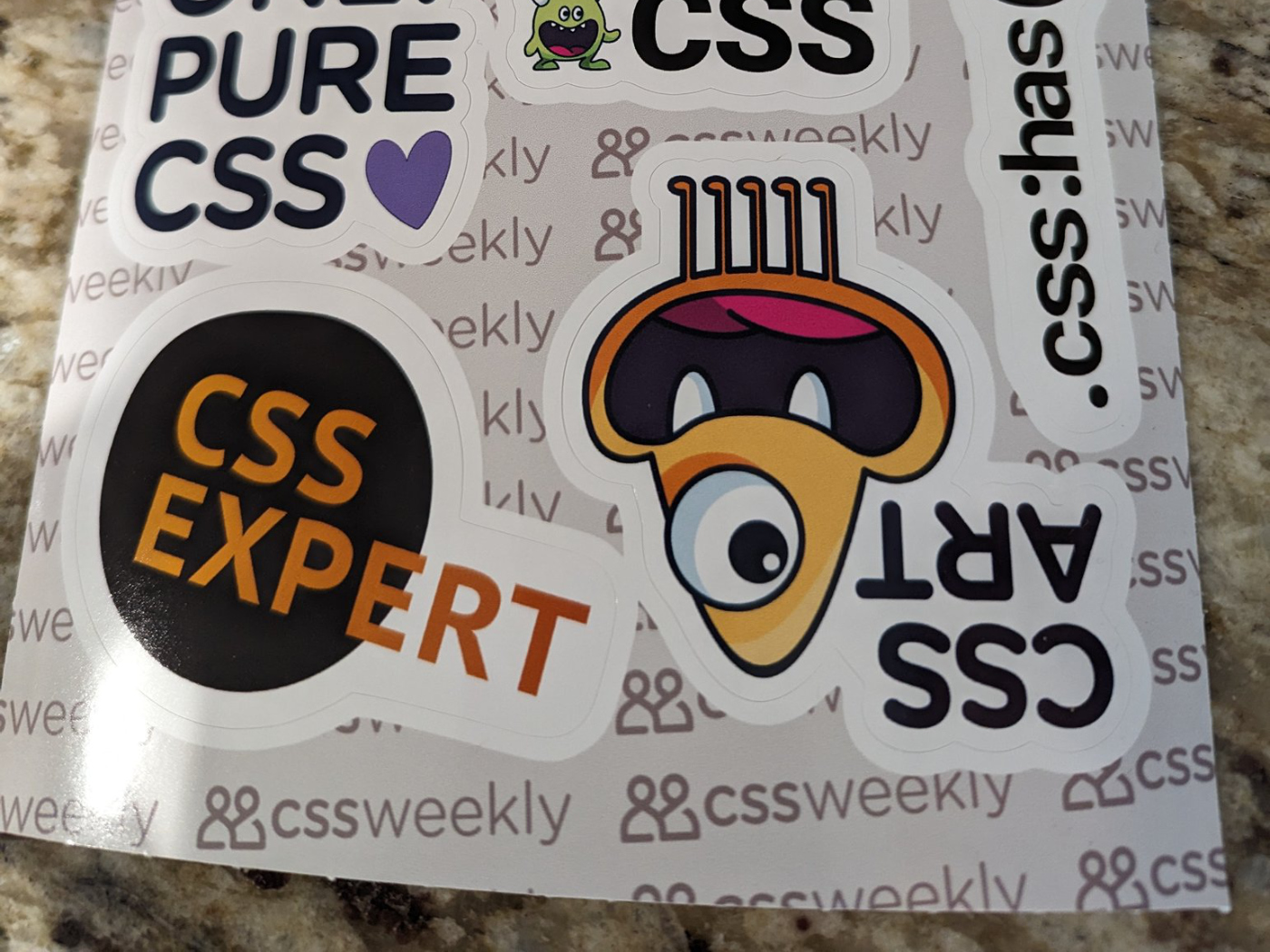 Kevin Powell's CSS Stickers sheet on a counter.